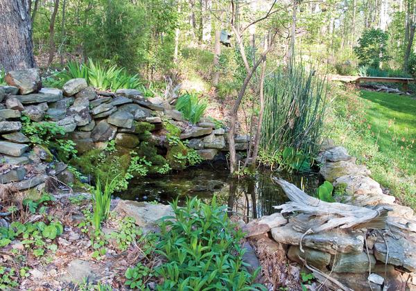 A landscaped water feature surrounded by stacked stones.